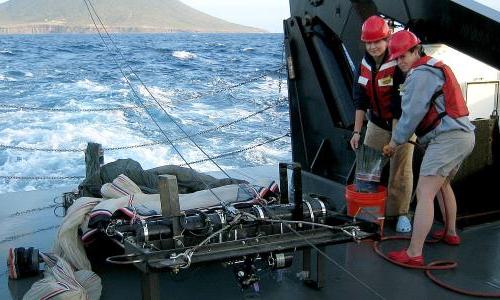 Two NOAA fisheries scientists on a research ship in the Virgin Islands